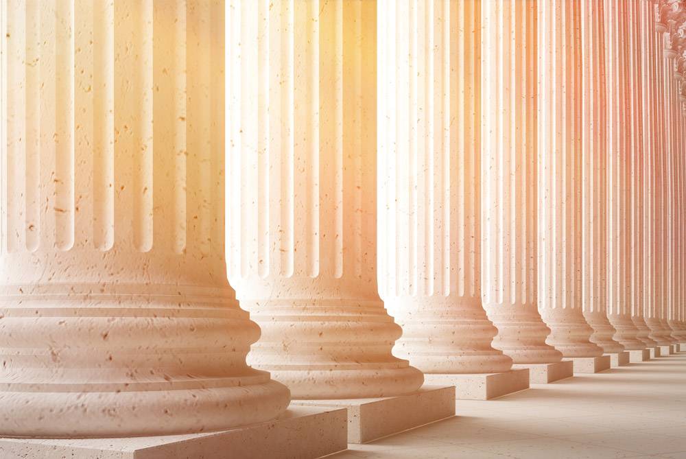 Pillars of a government building with sun shining through. Government background check concept.