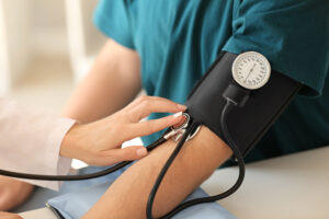 close up of doctor taking patient's blood pressure