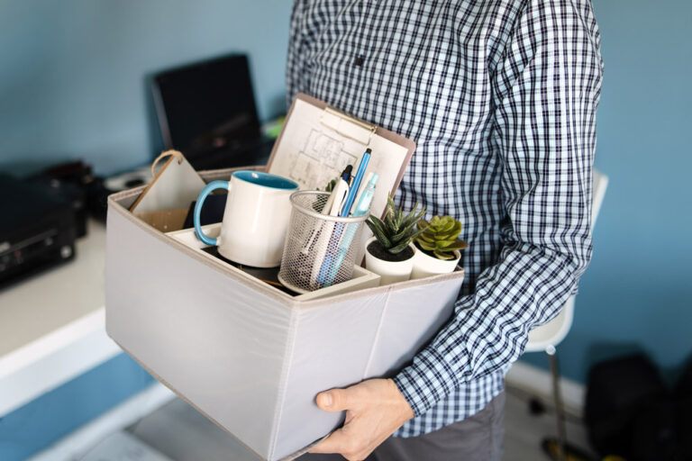 Man carrying box out of office. Termination concept.