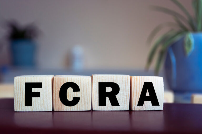 Blocks on a table with the letters FCRA. Compliance concept.
