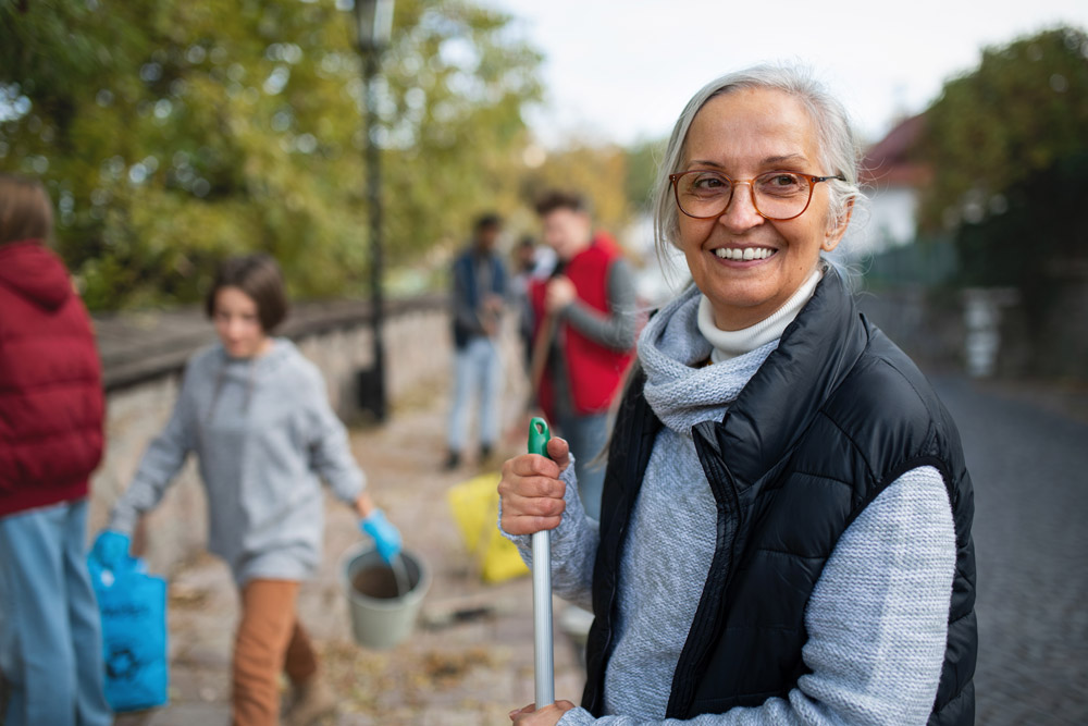 woman smiling at camera with volunteer group