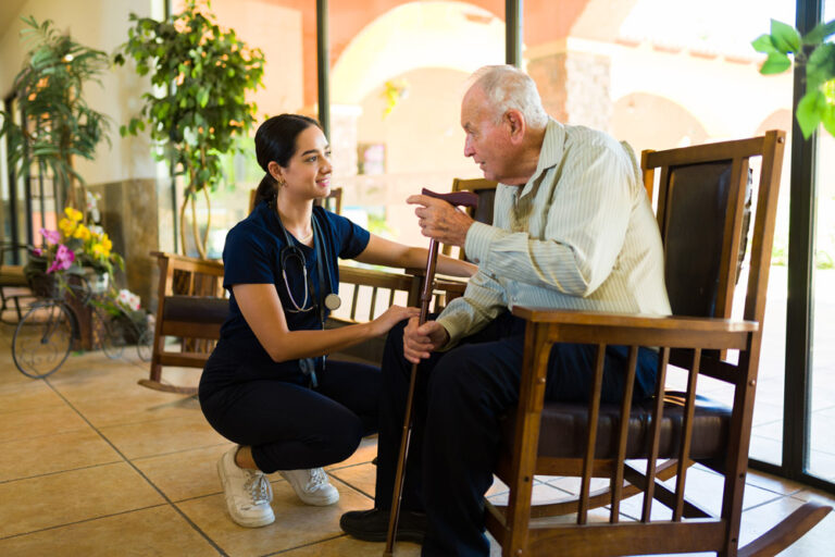 Nurse at the nursing home helping an elderly man